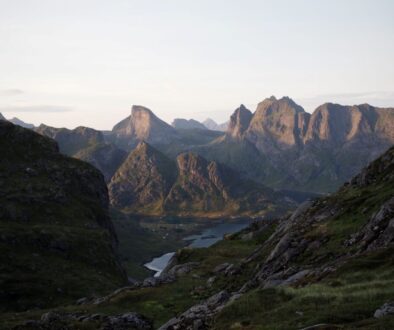 The sun going down on and illuminating the mountains surrouding forsfjord and reinefjord