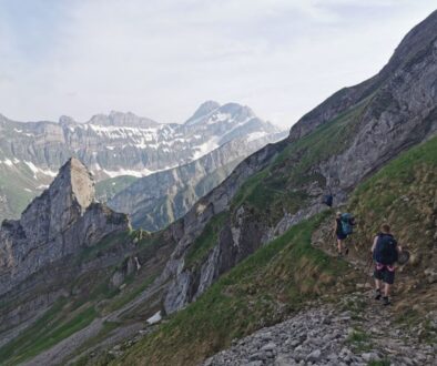 A group of friends hiking along the amazing geological limestone outcrops around säntis in appenzell, switzerland.